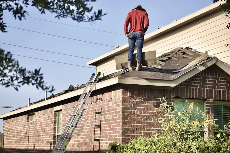 Professional roofer working on a residential roof in Polk Valley